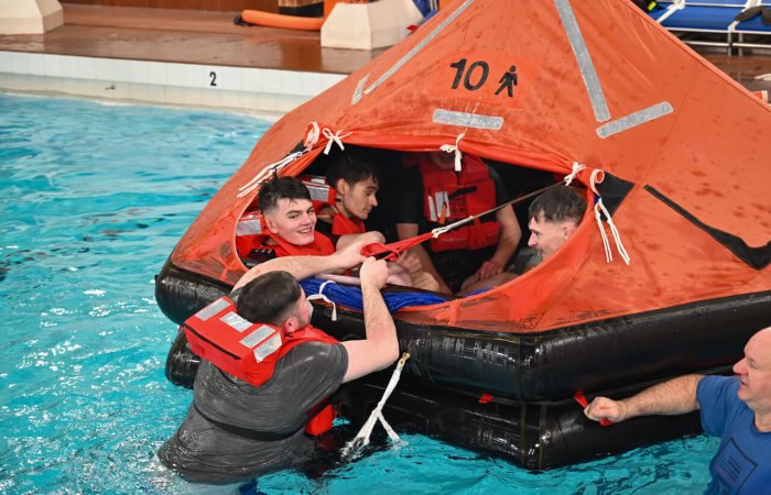 Safety Training with inflatable life boat in swimming pool