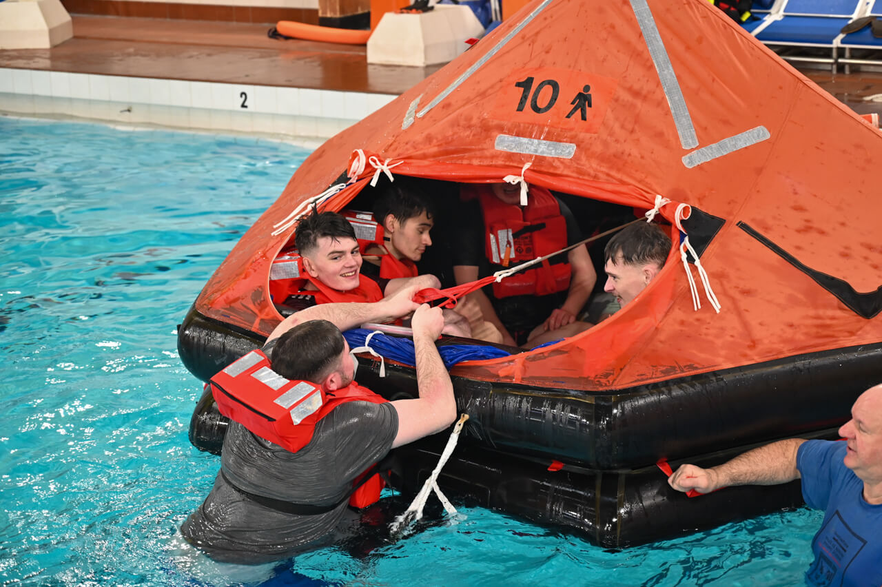 Safety Training with inflatable life boat in swimming pool